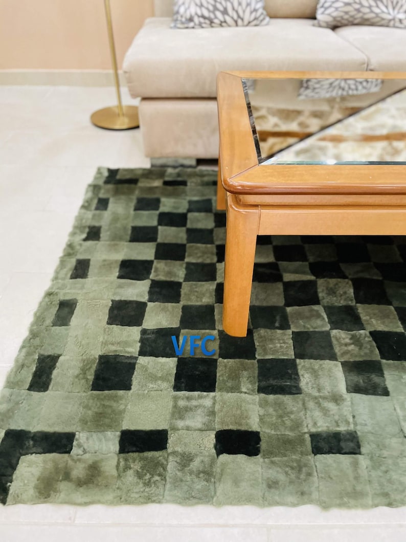 Pode incluir: Um tapete xadrez verde e preto com uma mesa de centro de madeira com tampo de vidro. O tapete &eacute; feito de um material macio e felpudo.