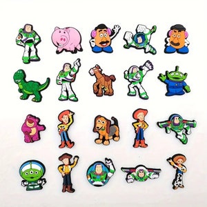 May include: A set of 18 colorful Toy Story character shoe charms. The charms feature characters like Woody, Buzz Lightyear, Jessie, Mr. Potato Head, and Rex.
