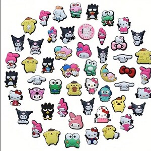 May include: A collection of colorful cartoon character charms featuring Hello Kitty, My Melody, Keroppi, and other Sanrio characters. The charms are made of rubber and are perfect for adding a touch of whimsy to your belongings.