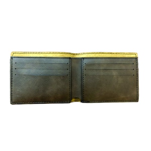 May include: A brown leather wallet with a yellow interior. The wallet is open and has multiple card slots.
