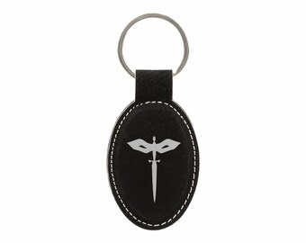 May include: Black leather oval keychain with a silver mask and sword design.
