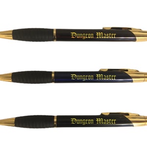 May include: Three black and blue pens with gold accents. Each pen has the words "Dungeon Master" engraved in gold lettering.