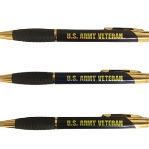 May include: Three pens with gold-colored tips and accents. The pens have a black rubber grip and a navy blue barrel. The text "U.S. ARMY VETERAN" is printed in gold on the barrel of each pen.