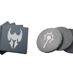 May include: Set of four gray slate coasters with white engraved designs. One coaster features a winged helmet, while the other three feature a mace with a spiked ball.