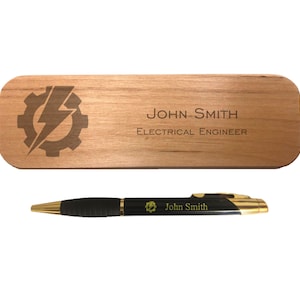 May include: A wooden desk nameplate with the text "JOHN SMITH ELECTRICAL ENGINEER" and a lightning bolt inside a gear. A black pen with gold accents and the text "John Smith" is also included.