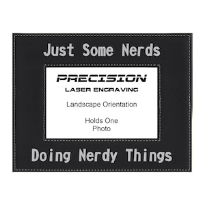 May include: Black leather picture frame with the text "Just Some Nerds Doing Nerdy Things" and the logo "Precision Laser Engraving" in white. The frame is designed to hold one photo in landscape orientation.