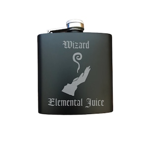 May include: Black stainless steel flask with a silver lid and a design of a hand with a swirl of smoke above it. The text "Wizard Elemental Juice" is engraved on the flask.