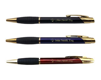 May include: Three black pens with gold accents and a gold scale symbol. Each pen has a different colored barrel: black, blue, and red. The pens are engraved with the text "I- John Smith, Esq."