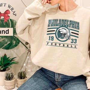 Philadelphia football sweatshirt designed with a classic unisex crewneck fit, ideal for Sunday football games, tailgating, or cozy fall weekends. This stylish and comfortable sweater is perfect for men, women, and kids who love showing Philadelphia team pride. Great sports apparel for football season, and a thoughtful gift idea for fans of all ages looking for quality game day clothing.