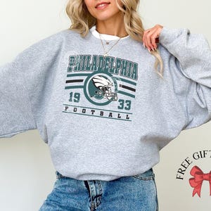 Philadelphia football sweatshirt designed with a classic unisex crewneck fit, ideal for Sunday football games, tailgating, or cozy fall weekends. This stylish and comfortable sweater is perfect for men, women, and kids who love showing Philadelphia team pride. Great sports apparel for football season, and a thoughtful gift idea for fans of all ages looking for quality game day clothing.