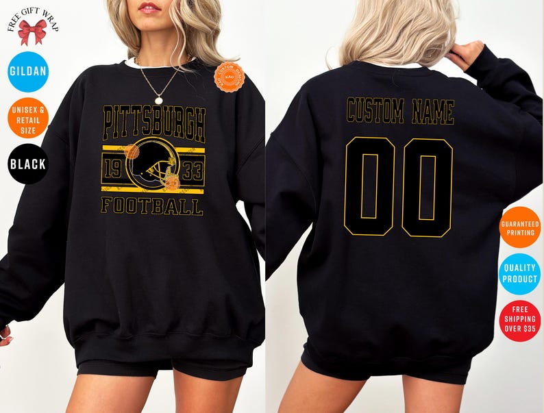 May include: Black sweatshirt with a gold and black Pittsburgh Football design on the front. The design includes a football helmet, the text "PITTSBURGH", "1933", and "FOOTBALL". The back features "CUSTOM NAME" and the number "00".