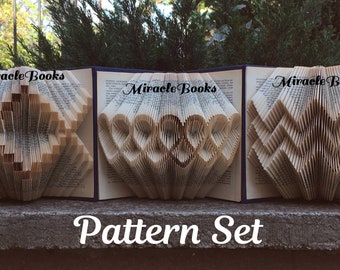 May include: Three open books with folded pages creating a star, heart, and diamond shape. The books are titled "Miracle Books" and the text "Pattern Set" is below the books.