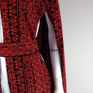May include: A red and black embroidered cape with a long, flowing design. The embroidery is intricate and detailed, and the cape is made of a soft, flowing fabric. The cape is perfect for adding a touch of elegance to any outfit.