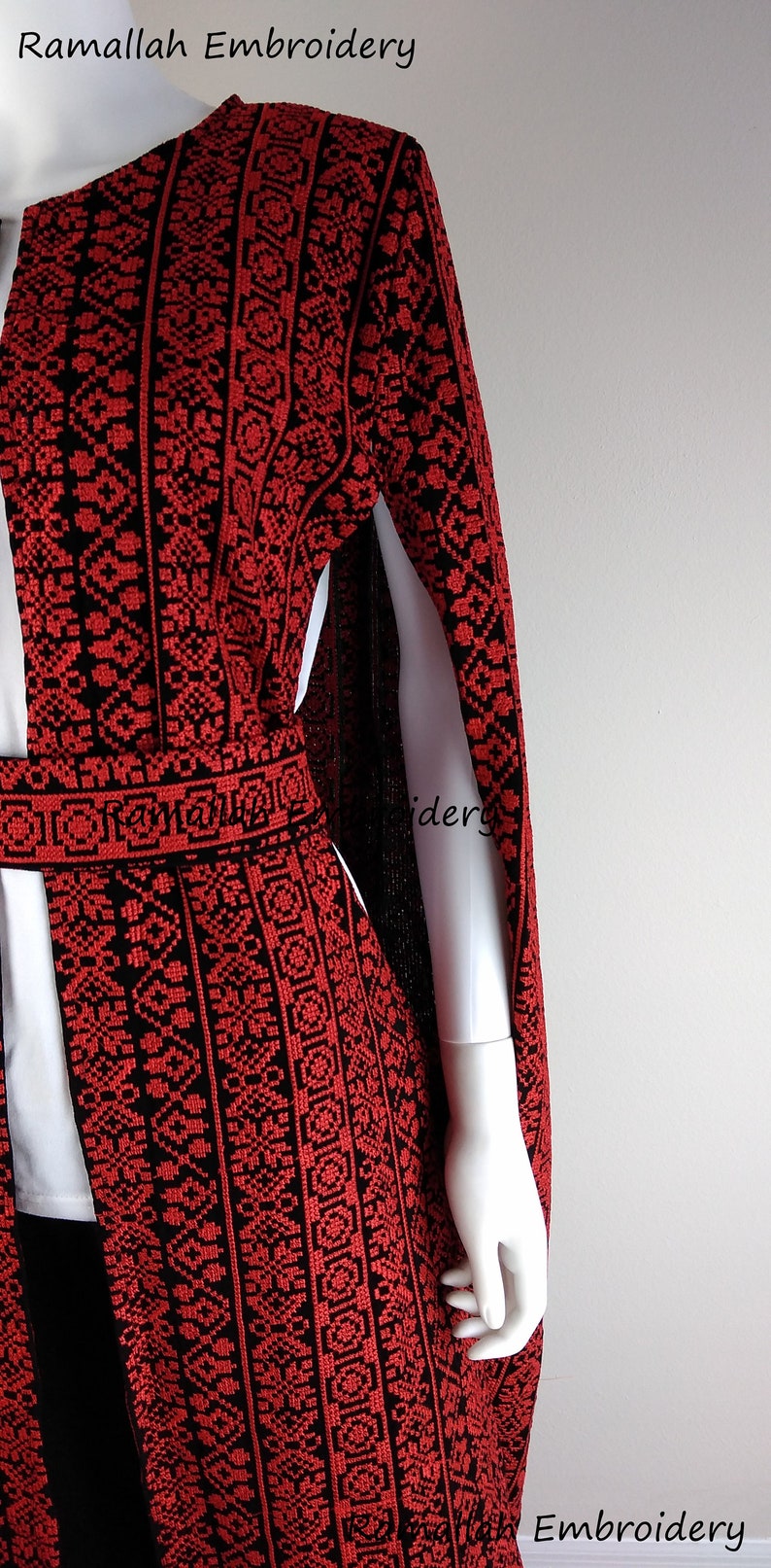 May include: A red and black embroidered cape with a long, flowing design. The embroidery is intricate and detailed, and the cape is made of a soft, flowing fabric. The cape is perfect for adding a touch of elegance to any outfit.