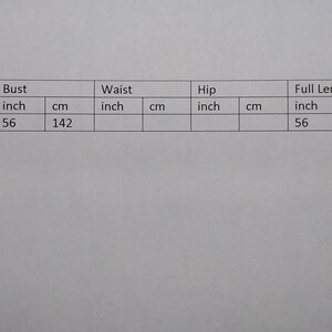May include: A table of garment measurements is displayed on a white background. The measurements are in inches and centimeters. The bust and full length are 56 inches (142 cm). The garment is one size.