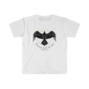 May include: White t-shirt featuring a black silhouette of a raven with the text "Once upon a midnight dreary" and "Edgar Allan Poe" printed on the front.