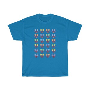 May include: A bright blue t-shirt with a pattern of colorful faces. Each face has a red mouth, two eyes, and a nose. The eyes are different colors, including blue, green, yellow, and orange.