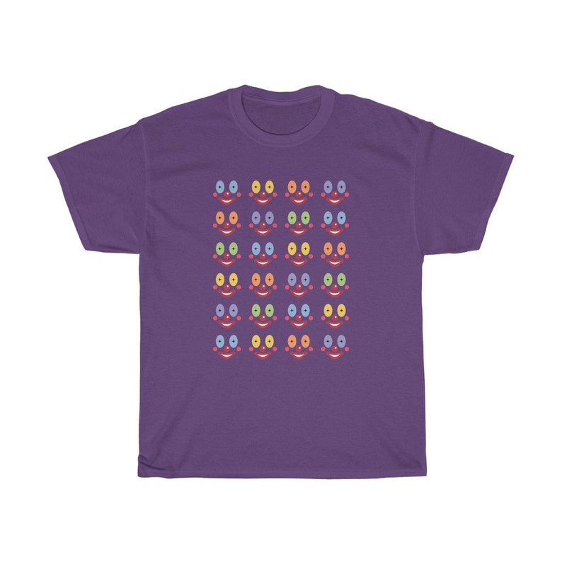 May include: Purple t-shirt with a pattern of colorful smiling faces. Each face has a different colored eye and mouth.