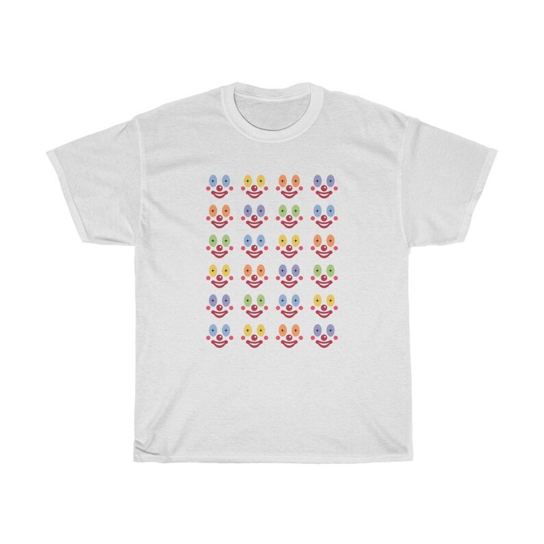 May include: White t-shirt with a pattern of colorful clown faces. Each face has a red nose and rainbow colored eyes.
