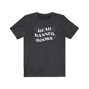 May include: A dark heather grey t-shirt with the text "READ BANNED BOOKS" in white lettering with stars around the text.
