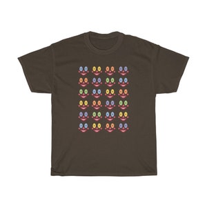 May include: A brown t-shirt with a pattern of colorful clown faces. Each face has a red nose, blue mouth, and rainbow colored eyes.