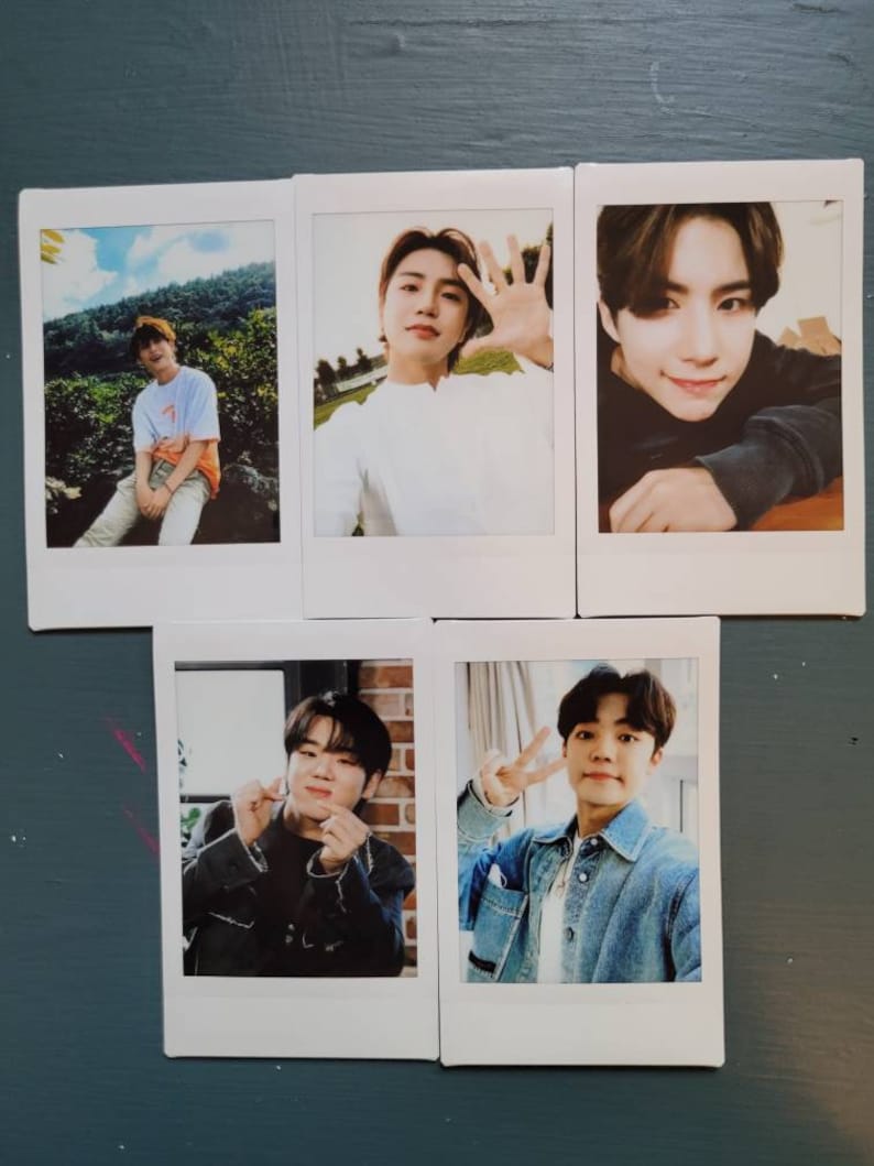 May include: Five Polaroid photos of a young man. The photos show the man in different poses and locations. The photos are all in a white frame.
