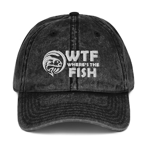 May include: Black vintage washed denim baseball cap with white embroidered text that reads "WTF Where's the Fish" and a stylized fish graphic.