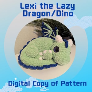 May include: A plush, light green dragon/dino toy with blue and white accents. The toy is lying down, with the text "Lexi the Lazy Dragon/Dino" and "Digital Copy of Pattern" in blue. The dragon has large, dark eyes.