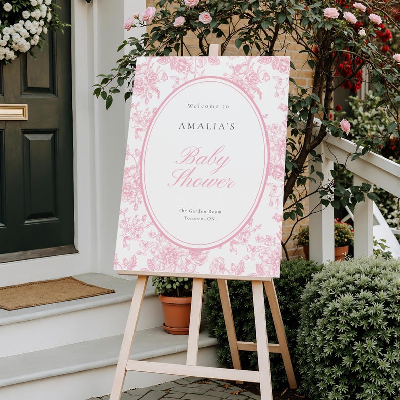 Editable pink baby shower welcome sign with French toile floral artwork and delicate oval frame perfect for upscale garden party and tea party celebrations