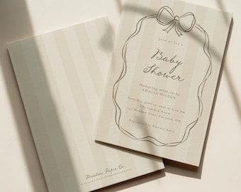 May include: Two baby shower invitations with a cream and beige striped pattern. One invitation is open, displaying the text "Baby Shower" within a decorative frame. The text includes the honoree's name, date, time, and location.