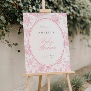 Printable floral toile baby shower welcome poster with soft blush pink pattern and elegant script letter perfect for feminine heirloom inspired baby shower decor