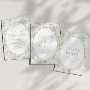 May include: Three rectangular signs with a sage green floral pattern and a central oval frame. The signs feature the text In Loving Memory, Cards & Gifts, and Guest Book, along with additional instructional text for wedding guests in a serif font.