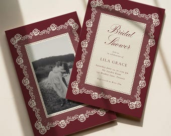 May include: Two rectangular bridal shower invitation cards featuring a deep burgundy background with a white lace-style floral border and a central cream-colored panel. One card displays text including Bridal Shower, Lila Grace, and event details.