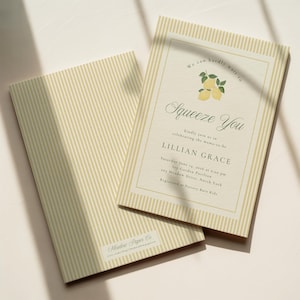 May include: Two baby shower invitations with a lemon theme. The invitations have a cream background with vertical yellow stripes. The text reads "Squeeze You" and includes event details. The back of the invitation has the same striped pattern.