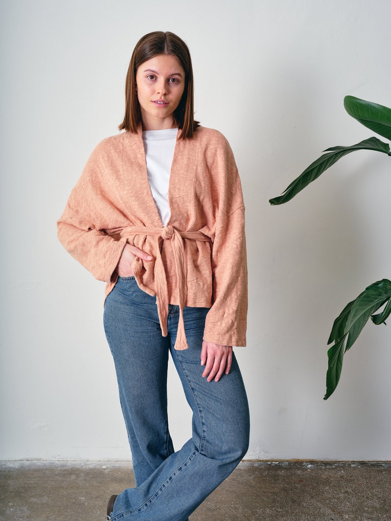 Belted Kimono Cardigan, a  versatile addition to your wardrobe. This open-front cardigan features a lightweight knitted design, perfect for a stylish and comfortable look. The oversized cotton jumper offering a fashionable and eco-friendly option.