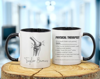 May include: White ceramic mug with a black handle and rim. One side features a knee joint illustration and the name "Taylor Barnes." The other side has the definition of "Physical Therapist" with humorous descriptions.