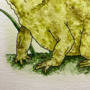 May include: A watercolor painting of a green frog with brown spots, sitting on green grass. The frog is facing the right side of the image.