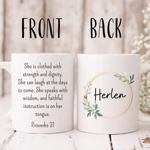 May include: White ceramic mug with a gold rim and green leaves. The front of the mug has a quote from Proverbs 31. The back of the mug has the name "Herlen" in a gold circle.