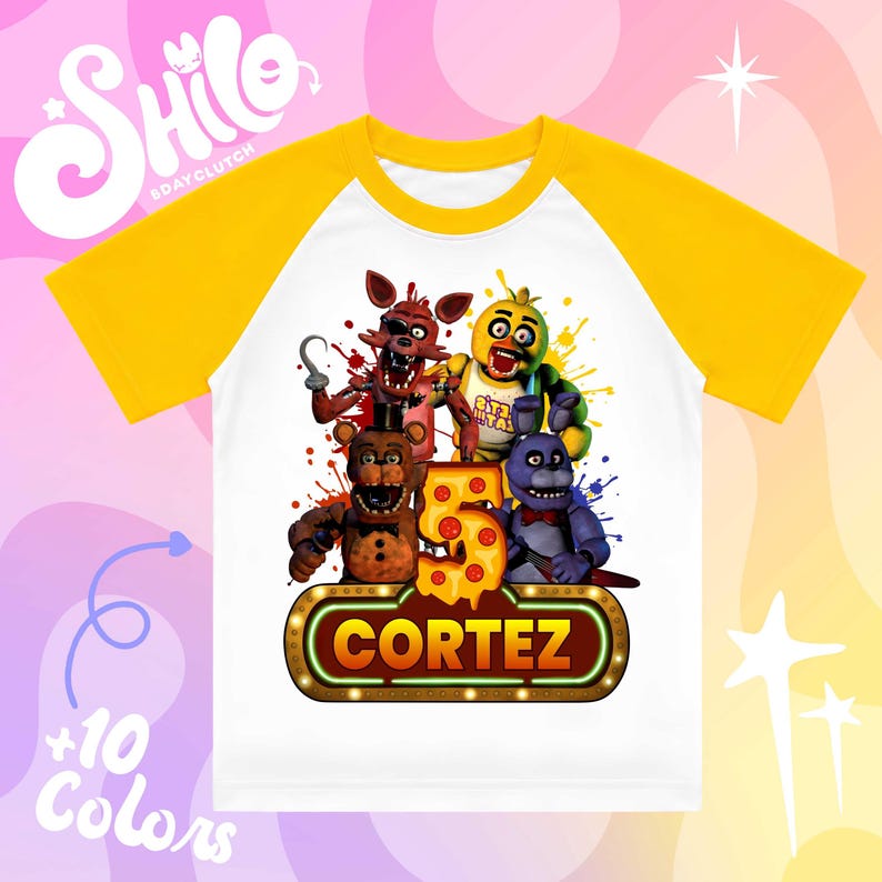 May include: A white raglan t-shirt with yellow sleeves featuring a graphic print of four animatronic characters, a large number 5 designed with pepperoni pizza slices, and a marquee-style sign with the name CORTEZ in bold yellow letters.