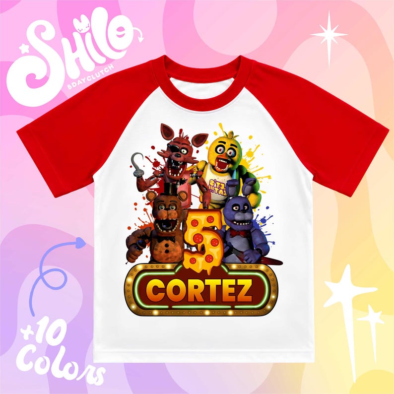 May include: A white t-shirt with red raglan sleeves featuring a graphic print of four animated characters, a large yellow number five with pepperoni details, and a rectangular sign with the name CORTEZ in bold yellow letters on a brown background.