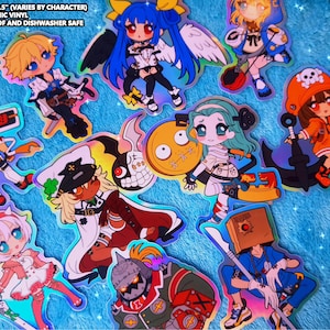 May include: A collection of holographic vinyl stickers featuring anime-style characters in various poses. The stickers are colorful, with a range of outfits and accessories. The text on the image says "SIZE: 2.5"-3.5" (VARIES BY CHARACTER) HOLOGRAPHIC VINYL WATERPROOF AND DISHWASHER SAFE."
