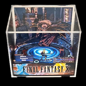 May include: A Final Fantasy X diorama encased in a clear acrylic box. The scene depicts a battle with characters and a monster, with game interface details visible. The game's logo is at the bottom.