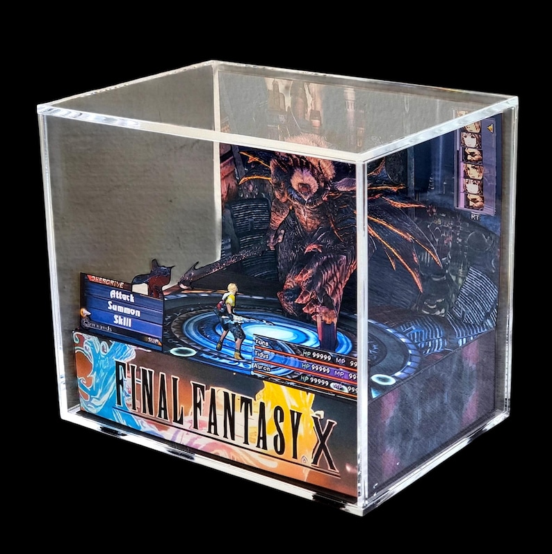 May include: A Final Fantasy X diorama encased in a clear acrylic box. The scene depicts a battle with a character in the foreground and a large monster in the background. The game's logo is visible on the front.