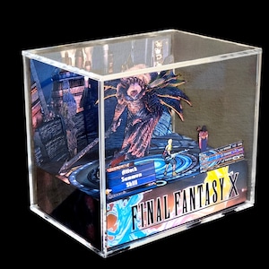 May include: A Final Fantasy X diorama encased in a clear acrylic box. The scene features characters and a monster from the game, with the game's logo prominently displayed. The artwork is detailed and colorful, set against a dark background.