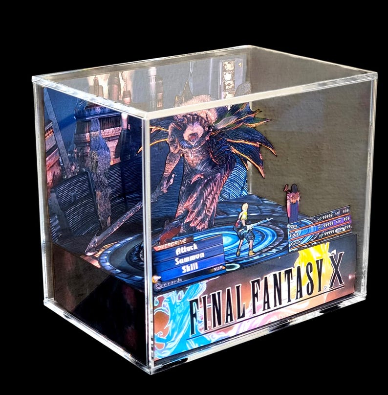 May include: A Final Fantasy X diorama encased in a clear acrylic box. The scene features characters and a monster from the game, with the game's logo prominently displayed. The artwork is detailed and colorful, set against a dark background.
