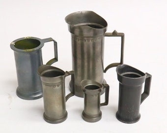 Five vintage pewter jugs