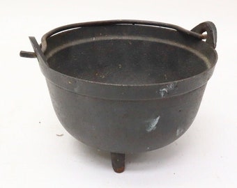 Antique iron cooking pot with legs