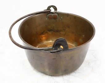 Antique brass cooking pot with handle.