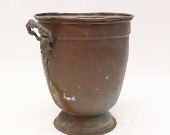 Antique copper pot with handles.