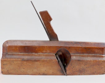 Antique wood plane with chisel.